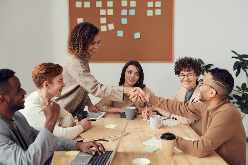Colleagues shaking hands during a collaborative meeting