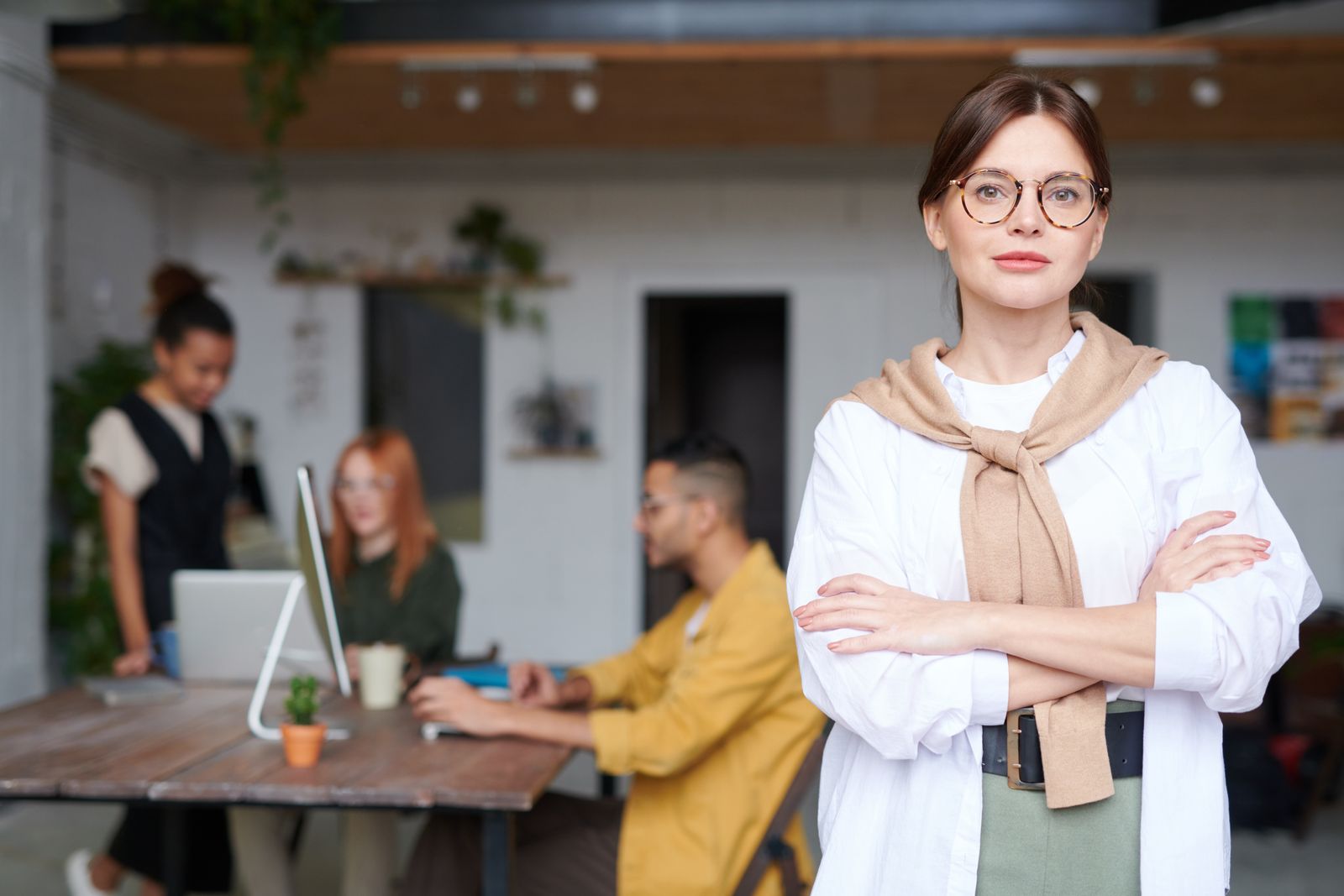 Creative professional with colleagues in a bright office